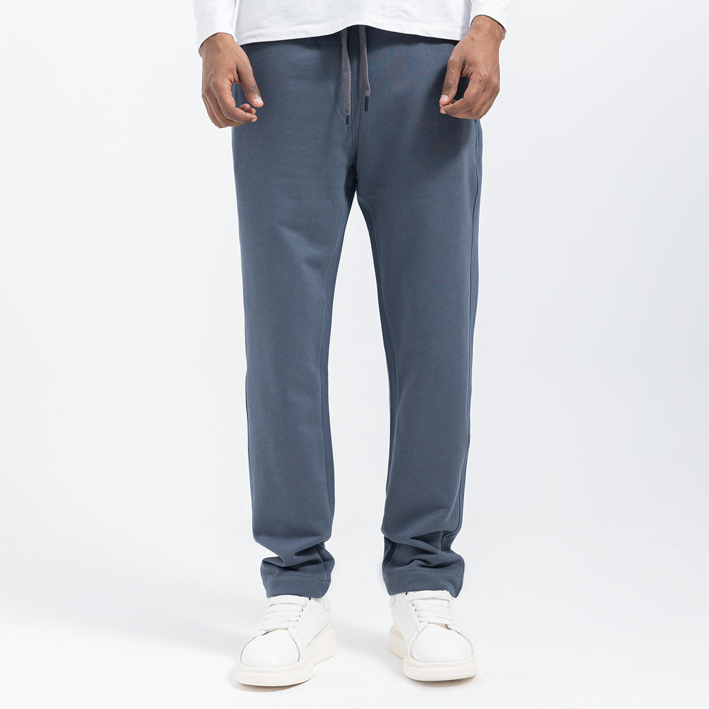 Person wearing gray sweatpants on a white background