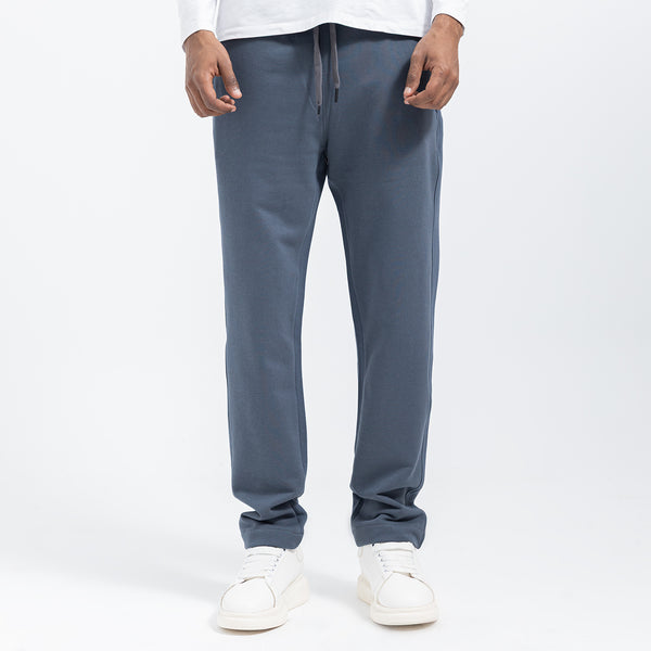 Person wearing gray sweatpants on a white background