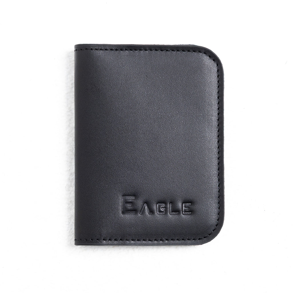 A black leather passport cover or wallet with rounded corners and the brand name 'EAGLE' embossed on the front, shown on a plain white background.