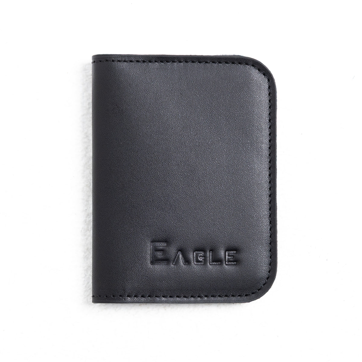 A black leather passport cover or wallet with rounded corners and the brand name 'EAGLE' embossed on the front, shown on a plain white background.